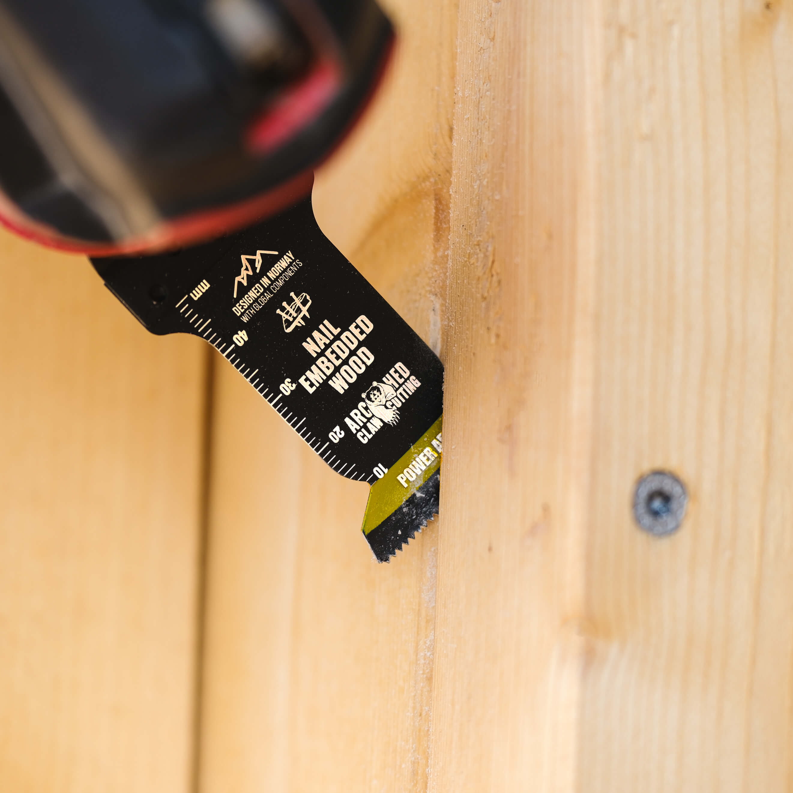 multi-tool blade cutting a screw in wood